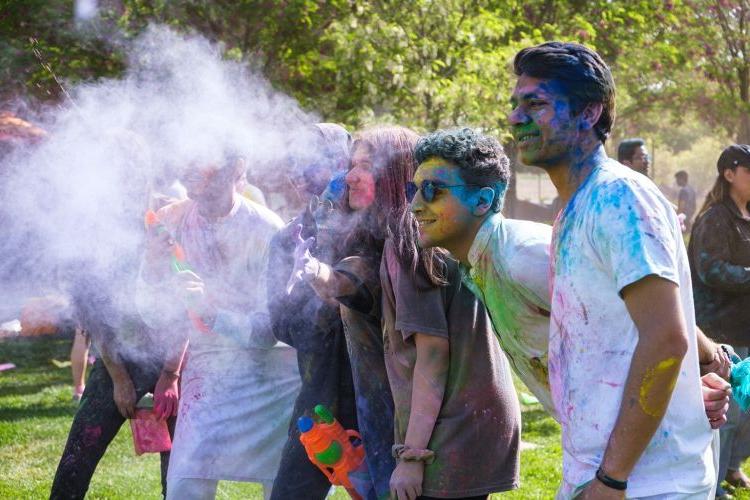 students pose for a photo at a holi event